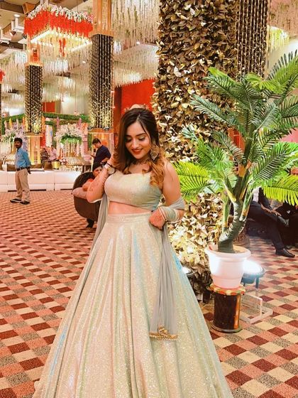 A beautiful mint green lehenga from The Azmat Official, perfect for a reception. The shimmer of the fabric is captured perfectly in the lighting.