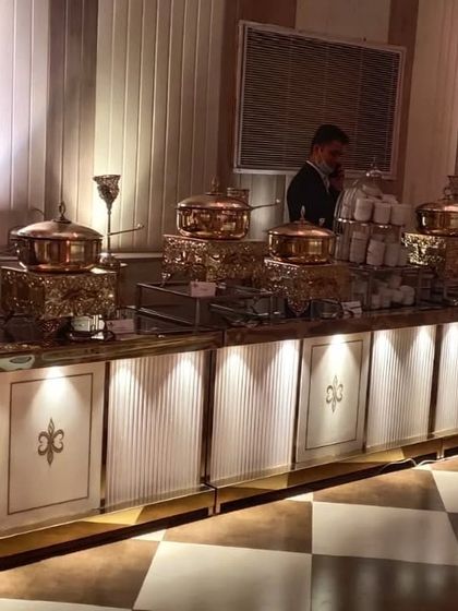 This view highlights the soup station and other main course dishes, all presented in beautiful copper serveware on an elegantly lit counter.