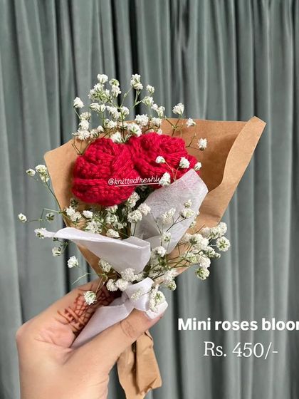 Sometimes, the smallest gifts make the biggest impact. This mini bouquet features two delicate red roses paired with baby's breath, all wrapped and ready to give as a sweet, thoughtful gesture.