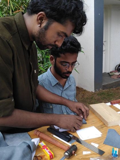 Our instructor, Griffith, providing one-on-one guidance during a leathercraft workshop. We ensure a supportive learning environment where you can master techniques at your own pace.