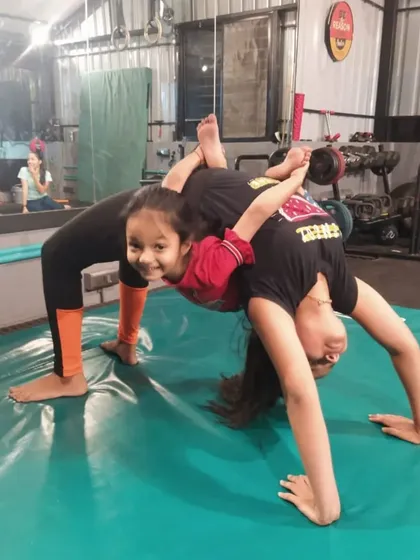 This two-person backbend pose is an excellent partner stretch that improves flexibility in the spine and shoulders while building trust.