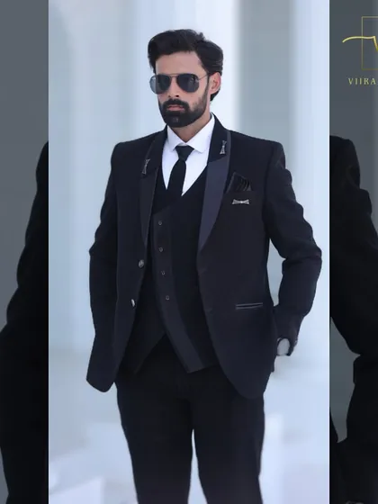 Our classic black three-piece suit, styled with aviator sunglasses for a cool, modern groom's look. The tailoring is sharp and the fit is impeccable.