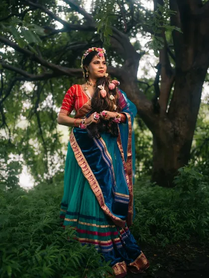 A portrait of Radha in a forest setting, her pose and expression conveying a sense of longing and devotion, enhanced by the natural light.