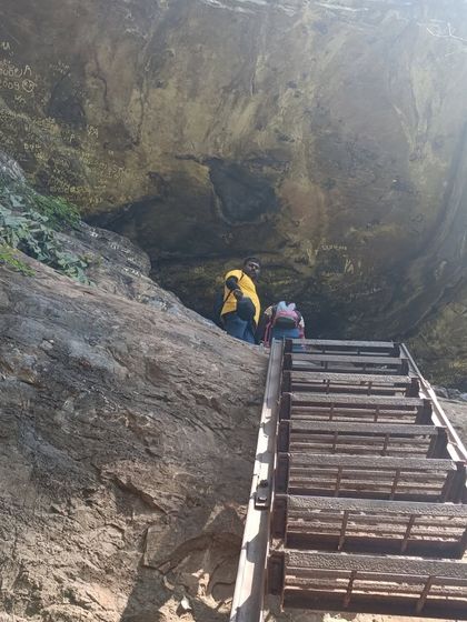A different angle of the ladder climb, showing the scale of the rock face.