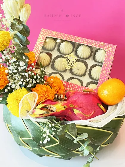 To welcome Bappa, I create hampers that bring together everything he loves. This vibrant basket is filled with traditional modaks, fresh marigolds, and assorted fruits, blending devotion with elegance for your Ganesh Chaturthi celebrations.