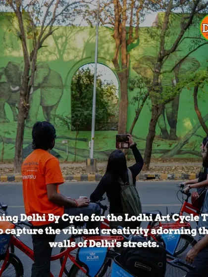 Capturing the creativity of Delhi's streets. A rider takes a photo of a mural depicting elephants, another stunning piece in the Lodhi Art District.