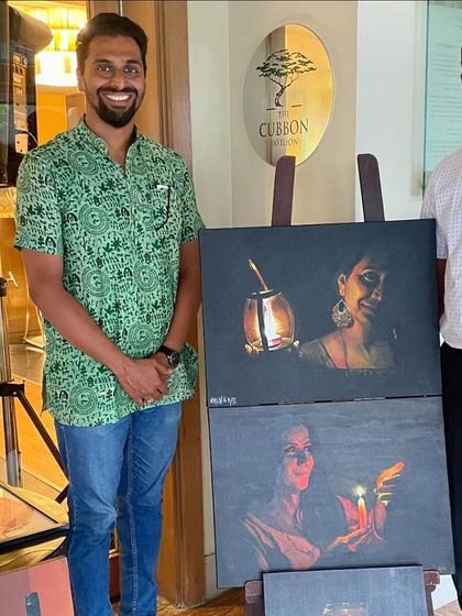 Posing with a visitor next to my paintings at the ITC Gardenia showcase.