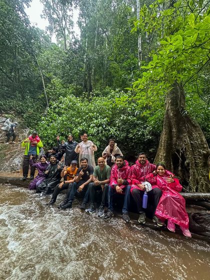 Our group sitting on a log, taking a break in a river during the Kodachadri trek.