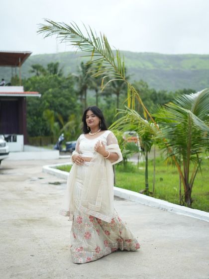 This white lehenga looks stunning against the natural green backdrop. A great choice for an outdoor event.