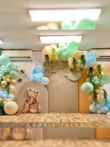 An adorable Winnie the Pooh "Oh Baby" shower. This sweet-as-hunny theme features Pooh Bear, honeycomb details, and a soft pastel balloon garland, creating a classic and heartwarming welcome for the new baby.