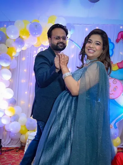 My rental gowns are not just for photoshoots. This client is glowing at her baby shower in a stunning, shimmery blue gown with an elegant cape. We also provided the suit for her partner, creating a polished look for their celebration.