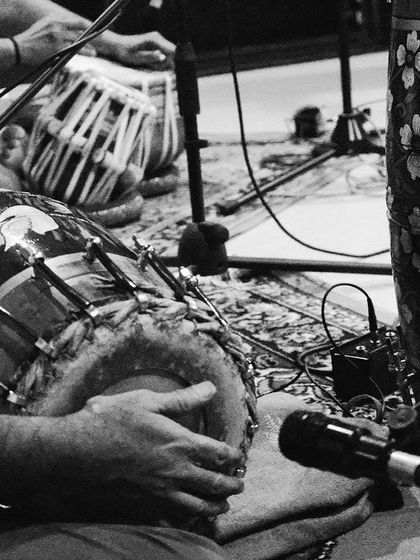A black and white photo from our rehearsal session for the 'Vari' album presentation. The focus is on the traditional percussion instruments, the heart of our rhythmic foundation.