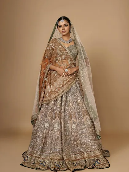 A full view of a breathtaking bridal ensemble. The makeup is kept elegant and defined to balance the intricate details of the lehenga, creating a regal and sophisticated look.