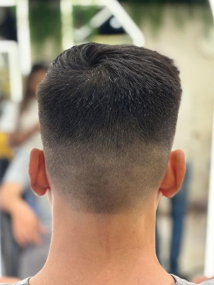 The back of a perfect skin fade, showing the seamless transition from skin to hair. This is precision cutting.