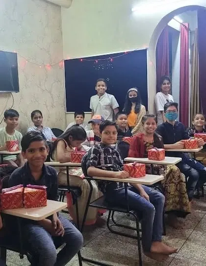 Distributing gifts to our students during the Diwali celebration. Seeing their happy faces is the best part of any festival.