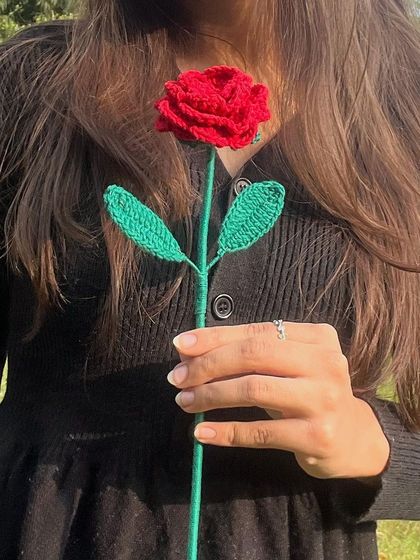 A single red crochet rose, a timeless symbol of love, handcrafted to last forever.