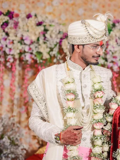 A classic portrait of the newly married couple. The groom looks proudly at his bride, showcasing their connection and the traditional beauty of their wedding attire.