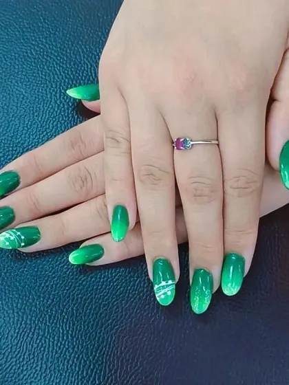 Another view of a student's work, highlighting the smooth finish and consistent shaping of the oval nails. We focus on teaching the fundamentals of nail technology for a professional look.