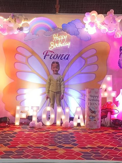 The butterfly-themed stage under bright lights, showing the beautiful details of the wings and the surrounding princess characters.