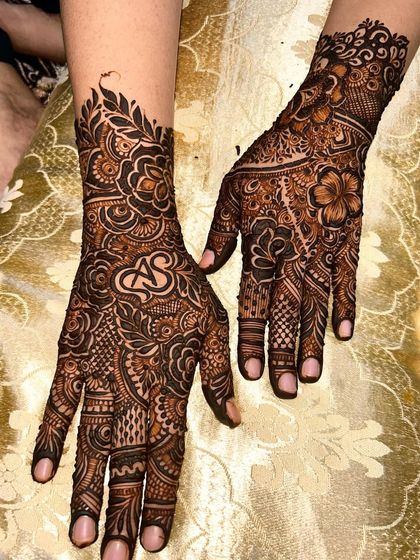 An elegant design featuring the initials "A" and "S" intertwined, placed prominently on the back of the hand.