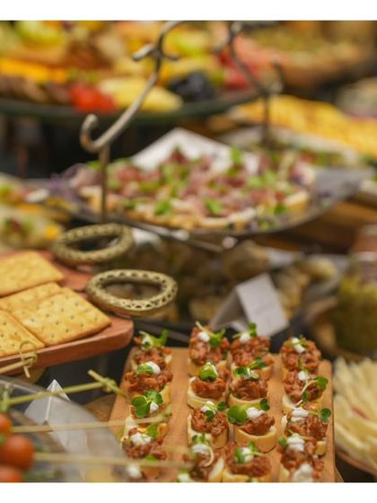 A detailed shot of a grazing table, showing layers of different canapés and snacks. The depth of field highlights the abundance and variety we offer.