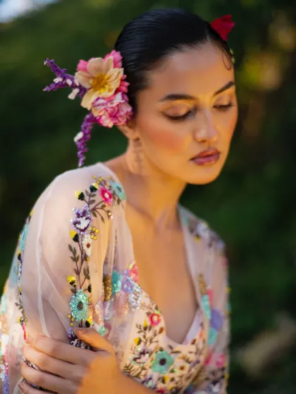 A soft and romantic close-up for Baavli. The model's serene expression and the delicate floral embroidery create a dreamy mood.