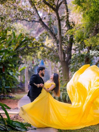 A romantic dance with a flowing yellow dress in a beautiful garden pathway.