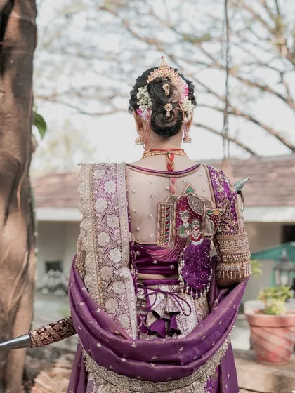 It's all in the details. This shot highlights the intricate work on the bridal blouse and the traditional Maharashtrian hairstyle, complete with floral accessories, showing my commitment to perfecting every element of the look.