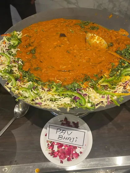 Mumbai's soul food, Pav Bhaji, served in a traditional large tawa. Our bhaji is a rich mash of fresh vegetables, cooked in butter and spices, ready to be enjoyed with soft, buttery pav.