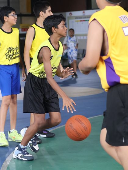 A player executes a low dribble during a match. The lessons from our drills translate directly into better performance in games.