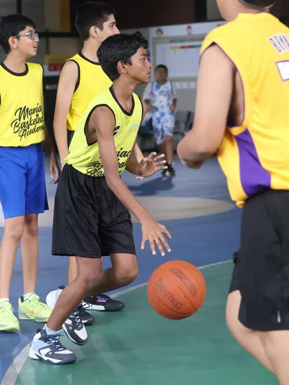 A player executes a low dribble during a match. The lessons from our drills translate directly into better performance in games.