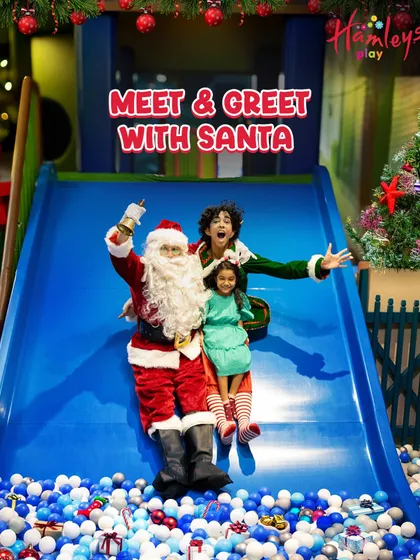 Guess who's sliding into the play area? Santa and his elf are here for a festive meet and greet! This photo captures a magical moment as they join a little guest on the slide.