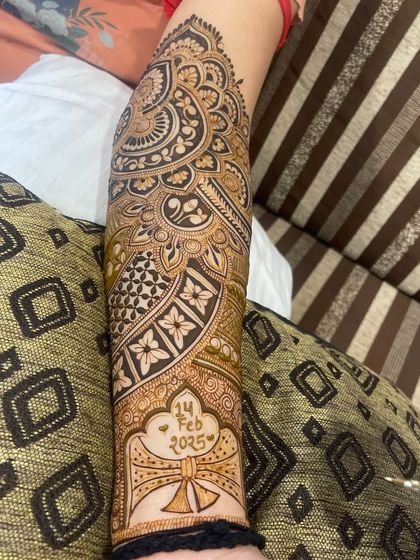 A closer look at the arm design with the wedding date, showing how it integrates with the surrounding paisley and floral patterns.