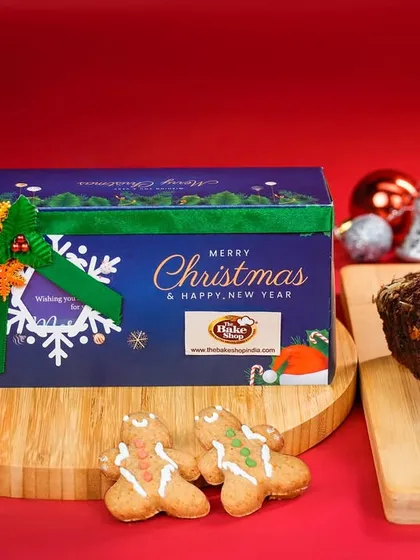The 'Jolly' hamper, a classic combination of plum cake and gingerbread men, presented in a beautiful Christmas-themed box.