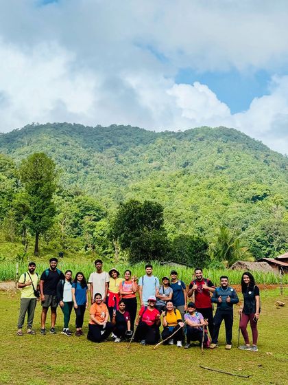 The group at the start of the Kodachadri trek, with the lush green base of the mountain behind them.