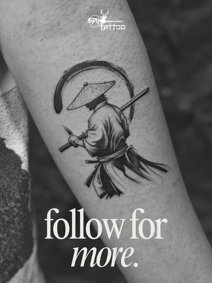 A minimalist but powerful black and grey samurai tattoo, captured in a moment of stillness, representing honor and courage.