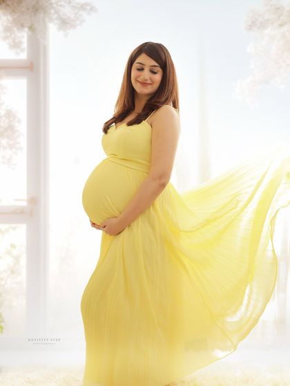 A bright and airy portrait in a flowing yellow gown. The wind effect on the dress and the soft backlighting create a feeling of freedom and joy.