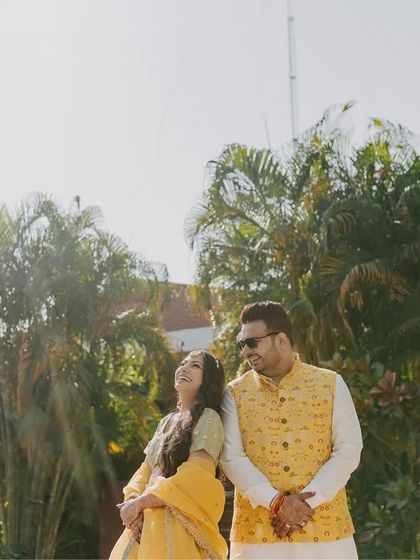 Tushar and Samta enjoying a sunny day during their celebrations. The bright light and their relaxed poses create a warm and cheerful portrait.