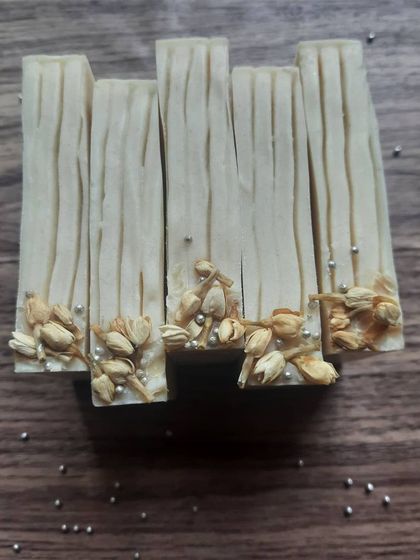 My Cooling Ice Apple soap, cut into elegant, slim bars. I adorn them with dried jasmine buds and silver pearls to reflect the delicate, cooling peppermint fragrance inside.