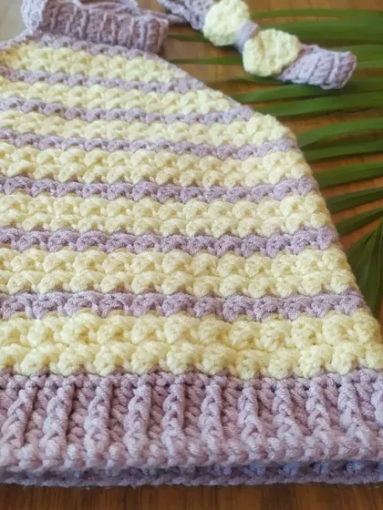 This close-up shows the beautiful texture of the Lavender Halter Top. The combination of stitches gives it a unique and high-quality finish.