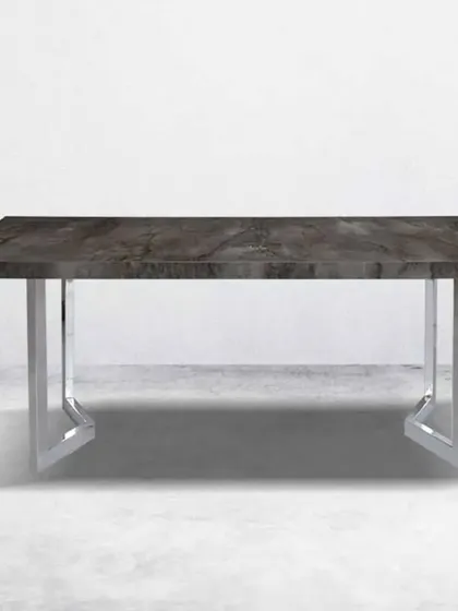 This dining table features a dark grey marble-finish top with a polished chrome base, offering a sleek and industrial-chic aesthetic.