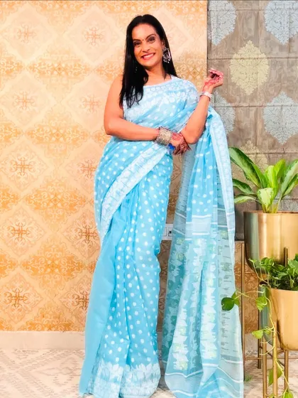 A lovely sky blue Jamdani saree with a polka dot pattern. It's a playful and charming design on a traditional handloom fabric.