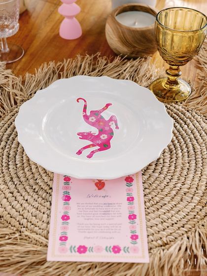 A custom-printed plate at the 'Villa Brissa' Mehendi, featuring a playful monkey motif. These personalized graphics add a layer of sophistication and charm.