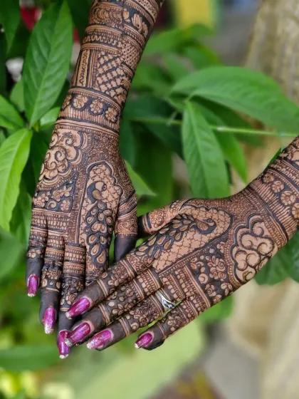 A close-up of the peacock motif on the palm, a symbol of grace and beauty in Indian culture.