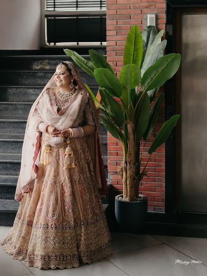 A portrait of a modern bride. Her pastel-toned, intricately embroidered lehenga is a perfect example of a serene and graceful bridal aesthetic for an Anand Karaj.
