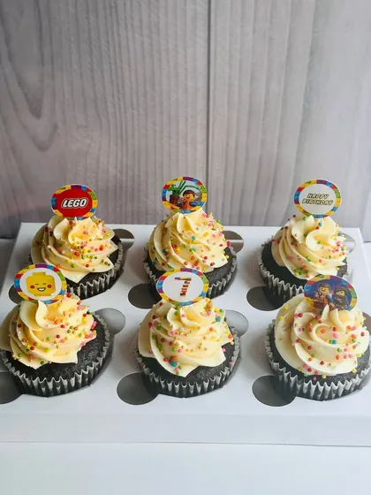 For the little builder in your life, I offer Lego-themed cupcakes. This set of six chocolate cupcakes is topped with vanilla buttercream, colorful sprinkles, and fun Lego paper toppers, making them a perfect birthday treat.