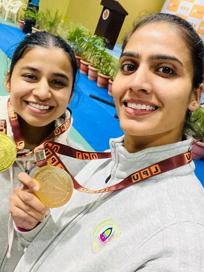 Gold medal winners Sonia Bhardwaj and Sonam Rawal celebrate their victory at the North-East Zone University Taekwondo Championship.