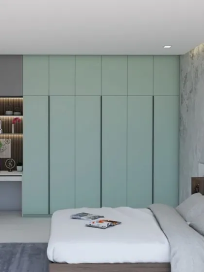 This modern bedroom design focuses on clean lines and smart functionality. We integrated a full-wall wardrobe with a built-in study nook, providing ample storage and a dedicated workspace without cluttering the room.