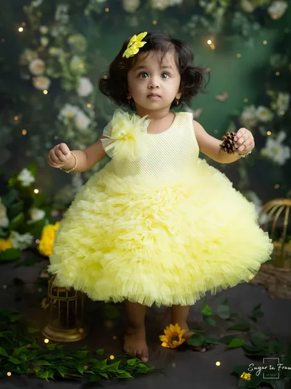 Standing in her magical garden, this little fairy is holding a pinecone, exploring the textures of her enchanted world.
