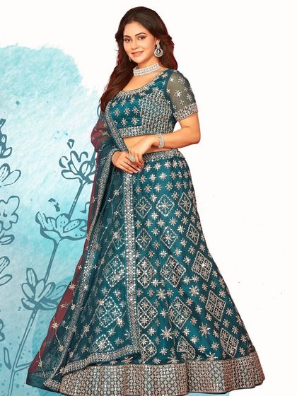 A mesmerizing teal lehenga with geometric silver embroidery. This is a modern and chic option for a wedding guest or bridesmaid.